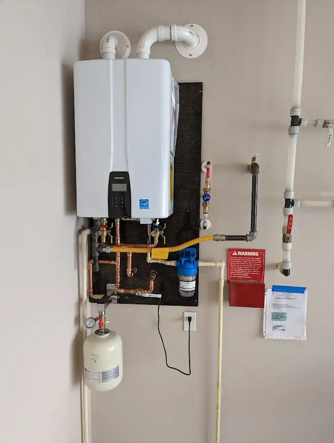 Professional plumber installing copper piping in a North Druid Hills home